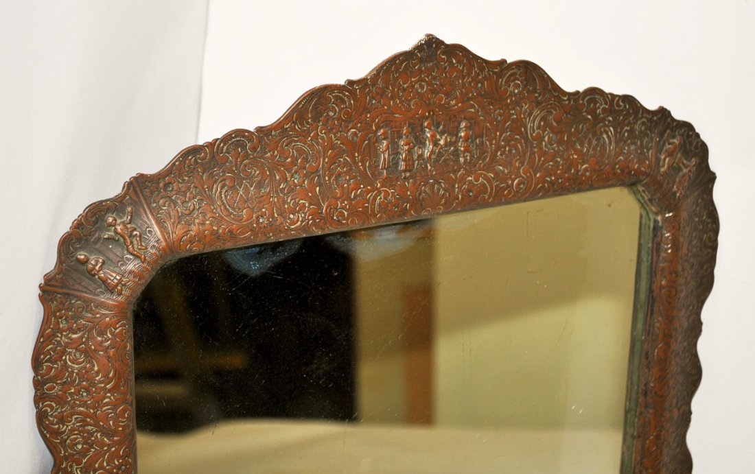 Antique Hallmarked Silver Plate/Copper Mirror: Chased and hallmarked silver plate on copper framed mirror. Most of the silver has worn off to a nice patina, 18" H x 14" W, very good antique condition.