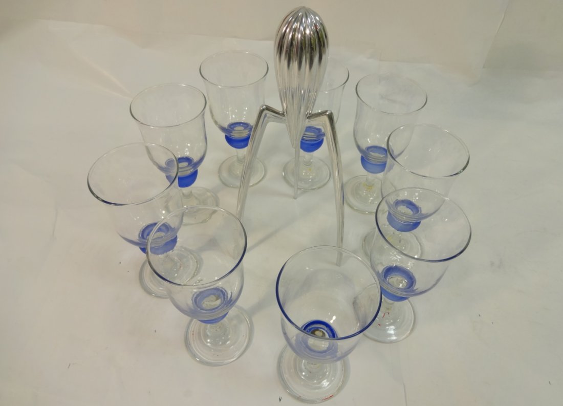 Mid-Century Lot of Chrome Juicer and Glasses: A lot of 9 mid-century glasses with a blue ball at stem top and a chrome juicer by Alessi, Italy. Glasses measure 3 1/8" dia. x 5/8" H. Juicer measures 5" W x 4 1/2" D x 11 3/4" H, excellent overall c