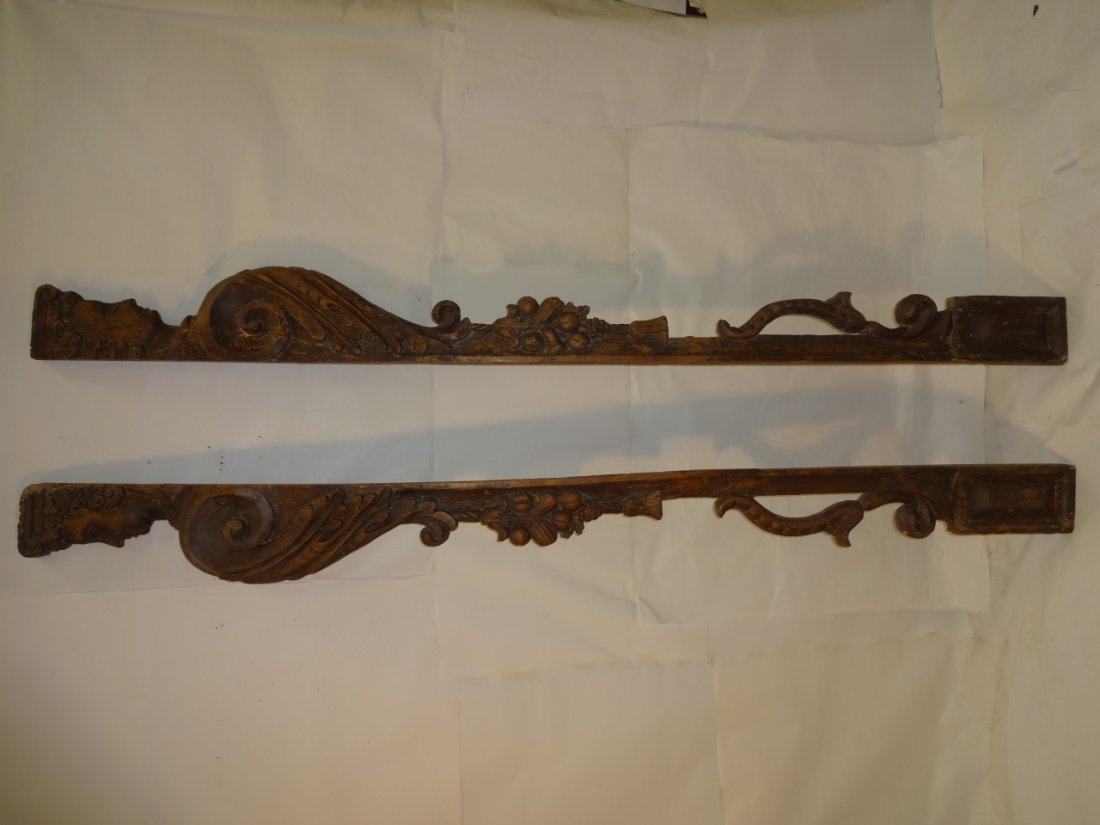 Pair of Antique Carved Wooden Doorway Frames: Pair of antique carved wooden doorway frames displaying a face (Bacchus?) and fruit. 8 1/2" W X 7 1/2" H.