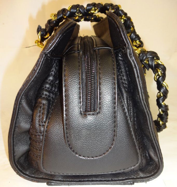 Quilted Black Leather Versace Handbag: A quilted black leather Gianni Versace hand bag with leather woven gold tone chain straps. Zipper closure with built in organizer and one zip interior pocket. 12 1/4" W x 5 3/4" D x 6 1/4" H. Excellen