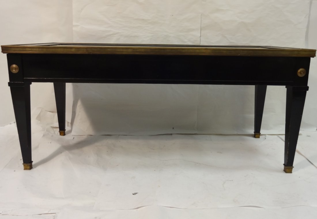Jansen-Style Black Lacquer Coffee Table: A Jansen-style black lacquer coffee table with brass trim and hardware. Two slides either end with tooled grey leather top. One center drawer. Recessed marble top. 39 3/4" W x 17 3/4" D x 17 3/8" H. V