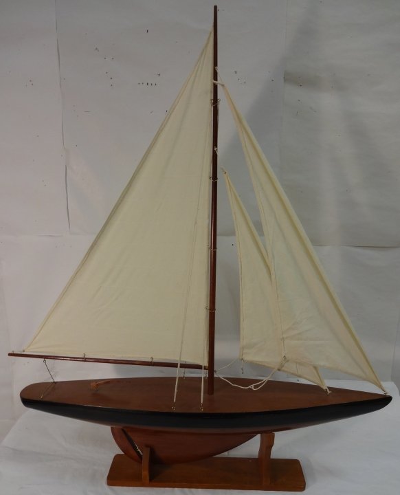 Model Sailboat with Display Stand: A two headsail model boat on display stand. 37" W x 6 1/2" D x 42" H. Excellent condition