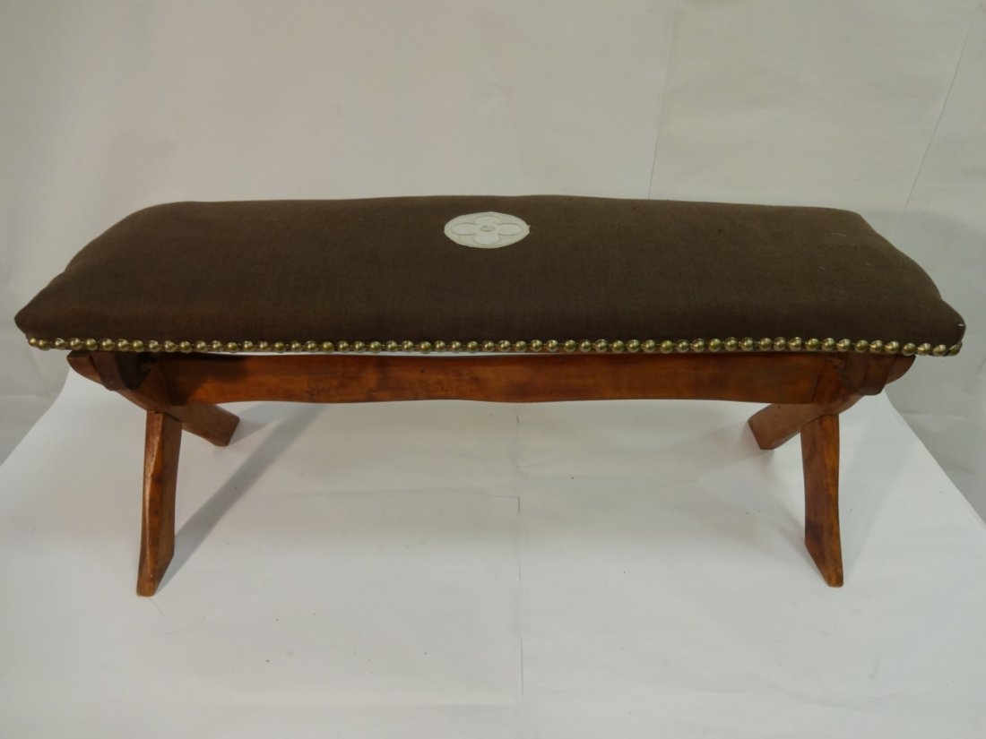 Louis Vuitton Small Bench with Center Medallion: A Louis Vuitton small bench upholstered in brown linen-like fabric with a center medallion logo, wooden base, and nail head trim. 30 1/4" W x 10 1/2" D x 14 3/4" H, very good vintage condition.