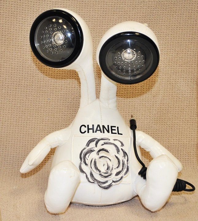 Vintage CHANEL Tribute Vinyl Speaker Set: Unusual Chanel twin speaker remote set for hand-held devices & Walkman type music apparattii. Measures: 12" high by about 10" wide. Good vintage condition.