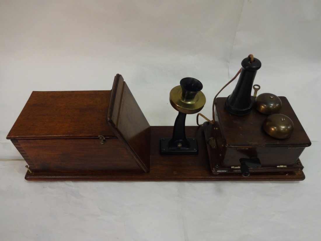 Old-Fashioned Wall Mount Telephone: An old-fashion wall mounted telephone with separate ear and mouthpiece. Double bell ringer. 8 1/2" W x 7 1/4" x 28" H. The mouth piece has been repaired otherwise good condition.