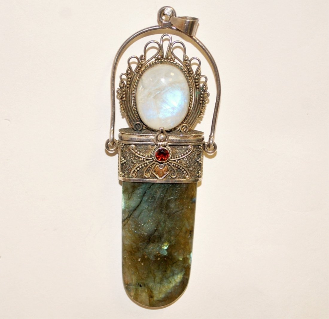 Antique Opal, Ruby & Jade Pendant Locket: Antique opal, ruby and jade pendant locket in silver or metal frame with a small area of gold, by Sasson. Secret compartrment & clasp. Measures 4.5" high by 1.5" wide by 0.5" thick. Very good conditio