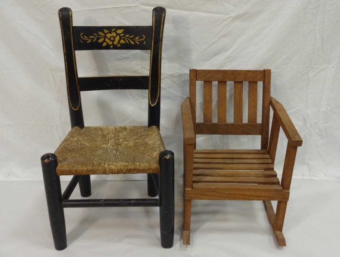 Two Children's Chairs: A lot of two children's chairs. A black chair with rush seat, 14 3/4" W x 11" D x 26" H. A slat seat rocking chair, 13 1/4" W x 15 5/8"D x 17 5/8" H. Both in good condition.