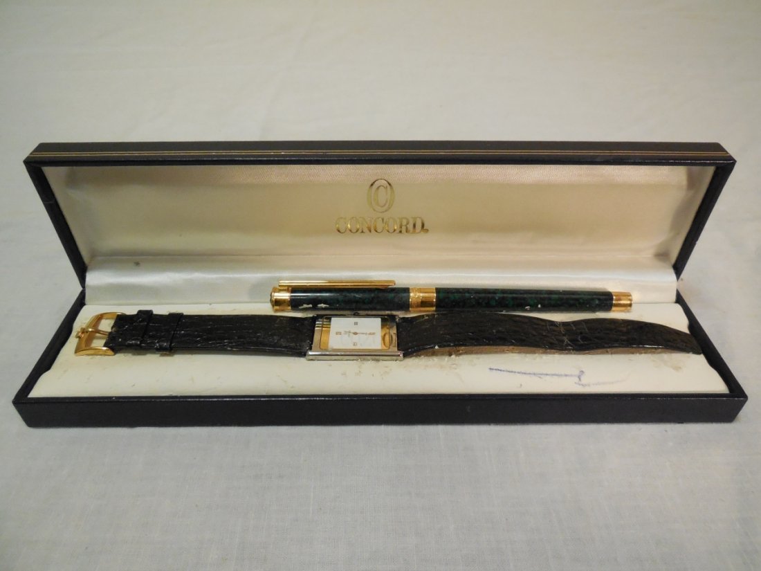 Concord Swiss Watch & Pen- Boxed Set: Concord Swiss watch and pen with original box. Strap measures 9 1/4" L, watch face measures 1 1/4" H x 1" W, very good condition with some sticker residue on verso.
