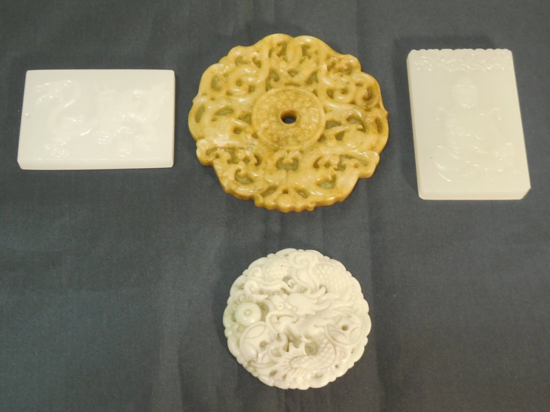 4 Pieces of Carved Chinese Jade: 4 pieces of carved Chinese jade. -a piece of round green carved jade, 2 7/8" Dia, -a piece of round white carved jade, 1 7/8" Dia,-a piece of rectangular white carved with deity, 2 3/8" W x 1 5/8" D,