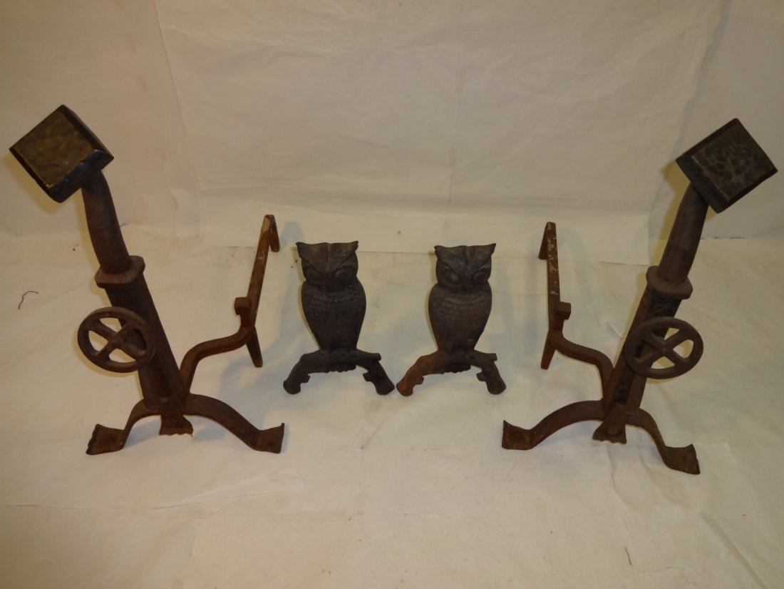 Lot/2 Pair of Antique Metal Andirons: A lot of two pair of antique black metal andirons. One pair owl andirons 8 3/4" W x 15" D x 14 1/4" H. The other with a decorative wheel motif 26" W x 14" D x 26 1/4" H. Both need some restoration on 