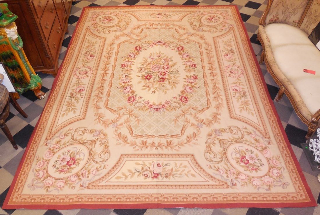 Chinese Needlepoint Area Rug: A Chinese needlepoint area rug in an Aubusson pattern. Red, brown and yellows. 138" L x 101 1 /2" W. Very good condition.