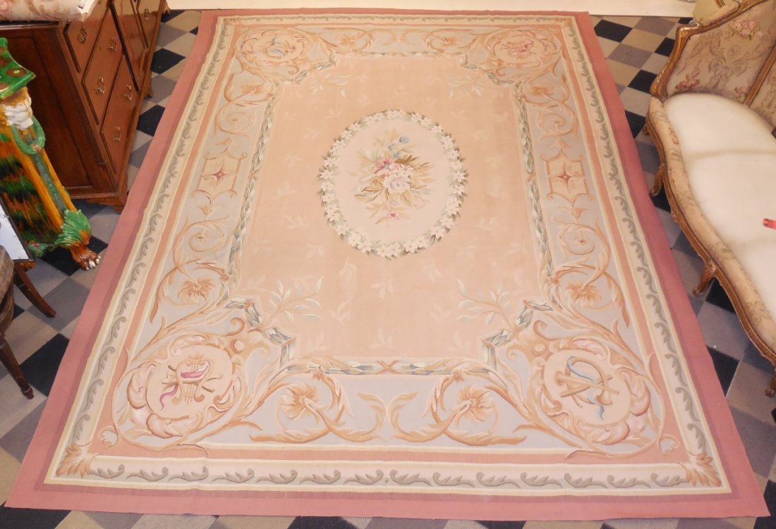 Chinese Needlepoint Area Rug: A Chinese needlepoint area rug in red, light blue and brown. 145 1/2" L x 106 1/2" W. Very good condition.