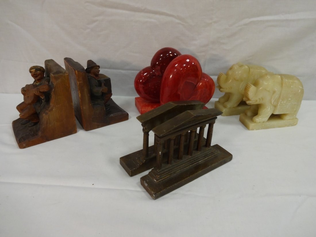 Lot of 4 Pair of Ornate Bookends: A lot of four pair of bookends. Wooden musicians, 8 3/4" W x 4 1/4" D x 5 1/2" H. Red stone heart shaped, 3/4" W x 4 3/4" D x 6 1/2" H. Alabaster elephants, 7" W x 3 3/8" D x 4 1/2" H. Metal Parthenon