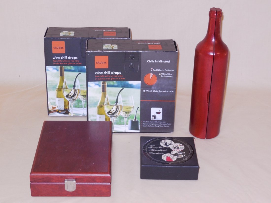 Lot of Assorted Bar Pieces: A lot of five assorted wine/bar pieces. Two boxes of wine chill drops, 8" W x 8"D x 3 1/8" H. A wood box with wine accessories, 6" W x 8 /4" D x 2 3/8" H. A wood bottle with wine accessories, 3 Dia. x