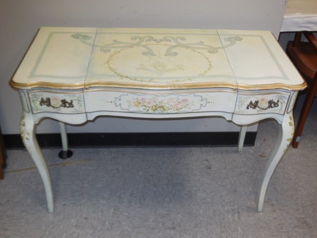French Hand Painted Dressing Table: A French hand painted floral design ladies dressing table with two drawers and center lift section with mirror. Monogrammed SA, by artist and dated '97. 42" W x 19" D x 29 H. Very good condition.