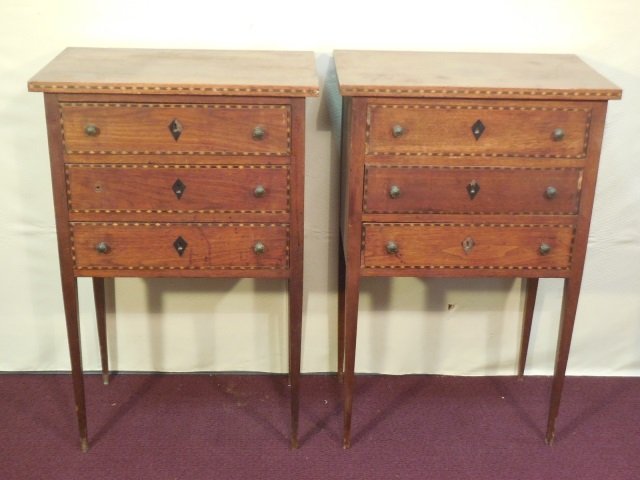 Pair of End Tables, Parquetry Detail 3 Drawers: Pair of end tables with geometric parquetry detail. Three drawers with keyhole escutcheons. 19 3/4" W x 12 1/4" x 30 1/2" H. Needs some restoration. One missing knob.