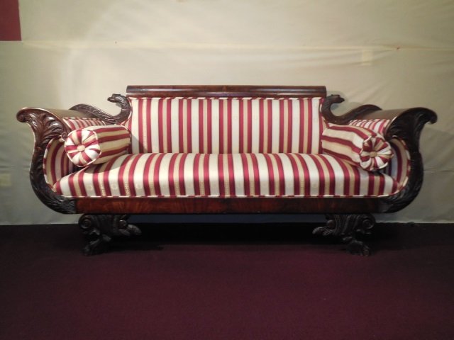 Empire Style Mahogany Carved Sofa/Settee: Empire style mahogany carved sofa/settee. Ornately carved frame. Upholstered in red and cream stripe silk. 77" W x 22" D x 34 1/4" H. Needs some minor restoration.