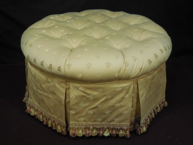 Round Upholstered Tufted Top Ottoman: Large round upholstered ottoman with skirt and tufted top. Napoleonic bee damask fabric. Tassel trim around hem edge. 37" diameter x 17 3/4" H. In excellent pre-owned condition.