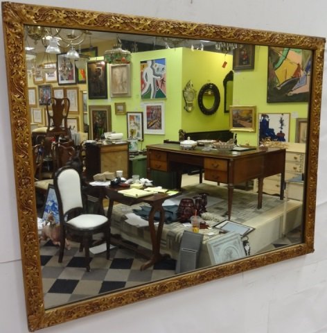 Antique Ornate Gilt Wood Wall Mirror: Ornate gilt wood wall mirror with entwined oak leaf and acorn frame embellishments. 43 1/2" W x 1" D x 33 1/4" H. Frame and glass in very good condition.