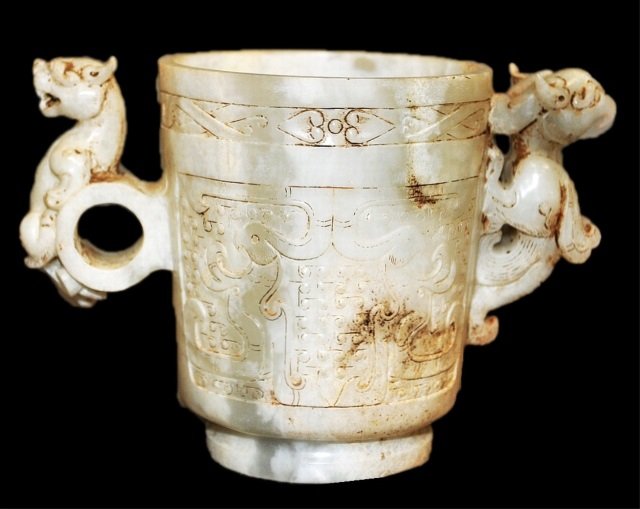 Exquisite Han Dynasty White Jade Two Handle Cup: Han Dynasty white jade two-handled cup or chalice with a carved dragon or bird frontpiece on one handle, the other side has a carved dragon motif. This ancient piece is in very good condition, conside