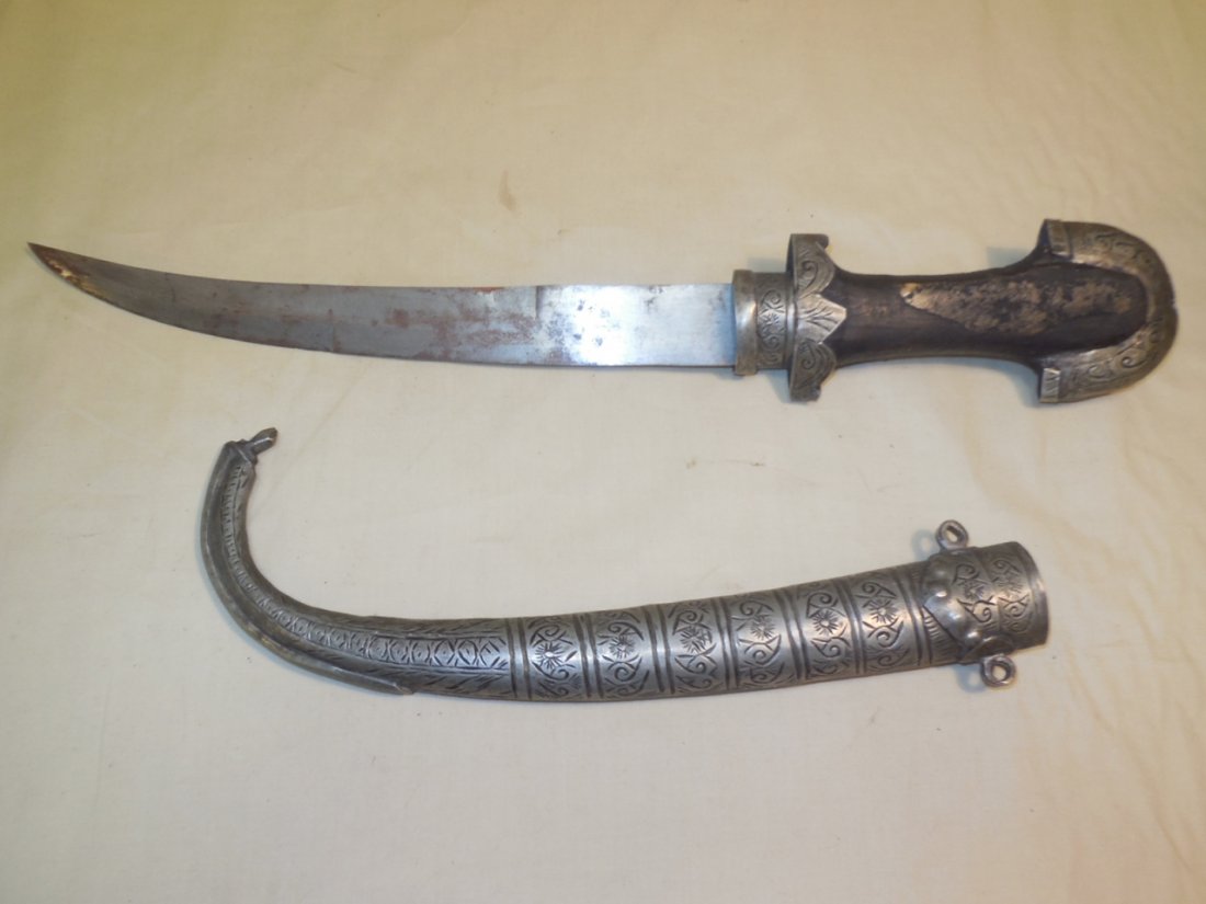 Vintage Arabian Knife Dagger With Sheath: Vintage Arabian knife dagger with sheath. Wood handle is adorned with carved metal. Sheath is heavily carved. 14 3/4" long x 3 1/2" W. In very good original condition. Shipping available within the Co