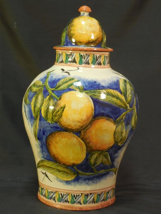 Painted Mexican Faience Pottery Jar W/ Lid: Painted Mexican pottery jar with lid. Bright lemons decorate the jar. Decorative purposes only. 6" diameter x 13" H. In very good condition.