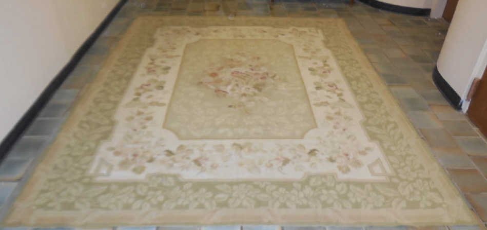 Chinese Needlepoint Floral Rug Green: Chinese needlepoint floral rug with soft green ground. Multi- color flowers, center has a lyre and horn motif. 9' 8" x 7' 9" In very good condition