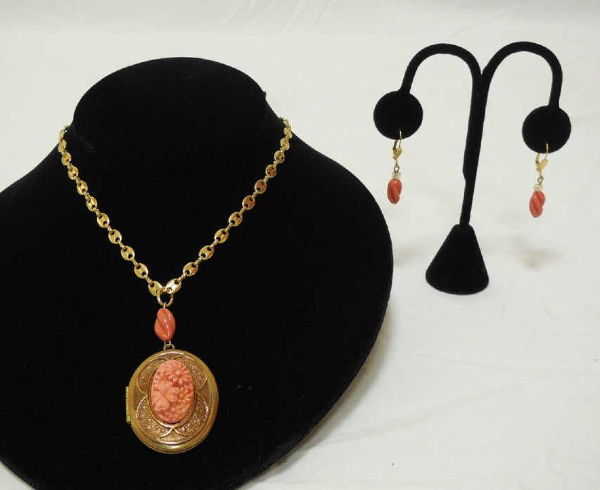 Vintage Carved Coral Locket & Pair of Earrings: Vintage carved coral locket and pair of earrings. Locket with central mount floral motif carved coral and bead. Earrings each with carved coral and glass beads. Gold tone chain and mountings. Locket 1