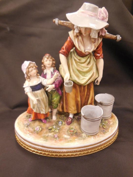 Large Antique Continental Porcelain Statue: Large antique continental porcelain statue. Showing a mother and two small children, having a gilt bronze ormolu base. Marked with N and a crown. Measures 11 inches in height, 10 inches in width and 7