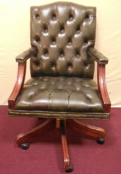 Vintage Tufted Leather Executive Desk Chair: Vintage tufted leather executive desk chair. Base with wheels. Measures 41 inches, 24 inches wide, 21 inches deep.