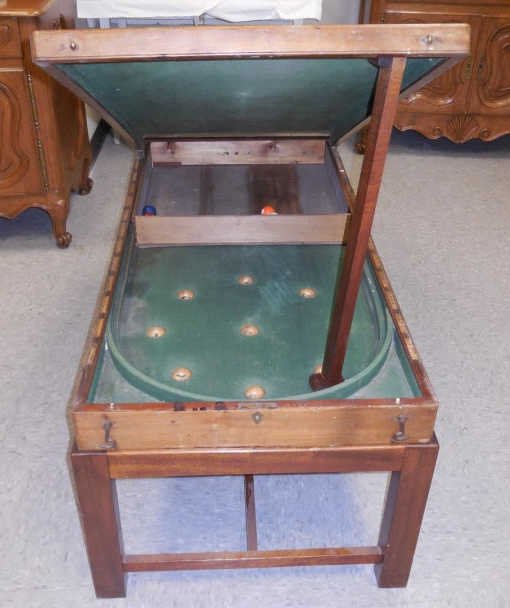 Antique English Pub Miniature Billiard Pool Table: Antique English pub billiard table. Top flips up to reveal green felt table. 26" W x 48" D x 21 1/2" H. Includes seven balls. In good original antique condition.
