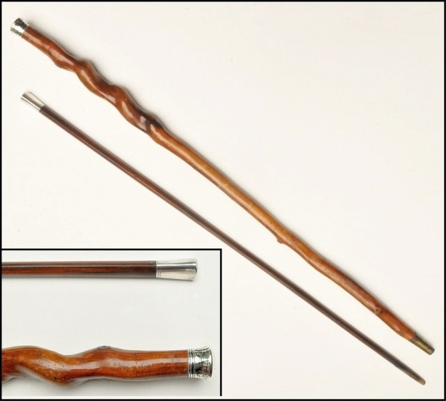 PR British Walking Sticks REID Sterling & Spiral: Pair of fine antique or vintage walking sticks from the UK. First is a corkscrewed solid wood shaft with a silver or silver-plate handle (no makers' mark) and brackets for hole that acommodated a stri