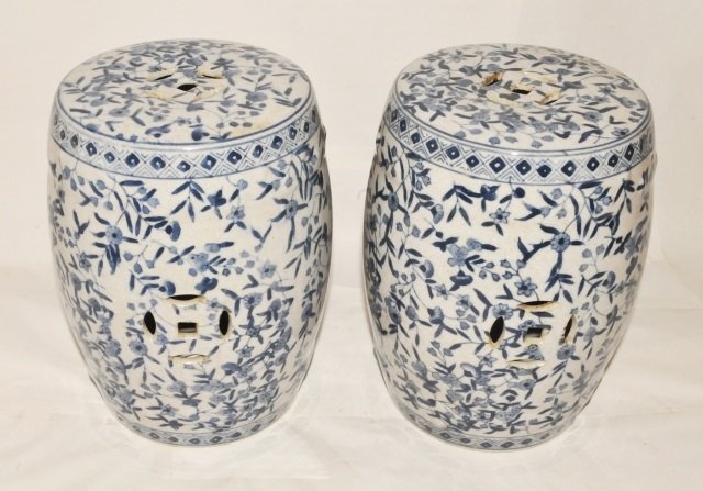 Pair Diminutive Vintage Asian Glazed Stools: Pair of diminutive vintage Asian garden or step stools made of glazed porcelain with a blue on white bamboo leaves and flowers motif. These stools are barrel shaped and are about half the size or less
