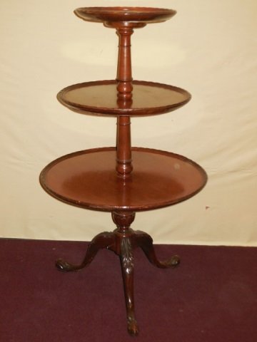 Antique Mahogany 3-Tiered Dumb-Waiter Table: Antique mahogany three tiered dumb-waiter server table. Carved edge detail. Carved three leg pedestal. 22" diameter x 39" H. In good condition. Needs some restoration.