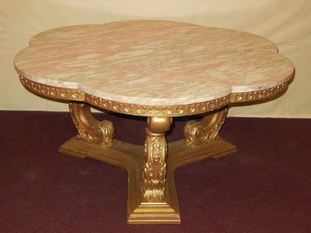 Mid Century Marble & Carved Wood Coffee Table: Pink marble top coffee table with carved wood base, gilt finish. Shaped top. 36" diameter x 17 1/2" H. In good condition.