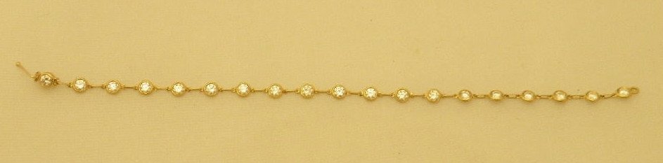 Tiffany & Co Elsa Peretti 2 Carat Diamond Bracelet: A Tiffany & Co. diamonds by the yard bracelet designed by Elsa Peretti in 18kt yellow gold with 19 round brilliant cut (approx. 2.0 cts). This vintage bracelet has bezel set diamonds. Marked Tiffany &
