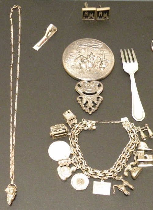 Assorted Sterling & Silver Jewelry & Articles: Assorted group lots of sterling and silver tone jewelry and small items. Including charm bracelet, hand mirror, earrings, clips, etc.