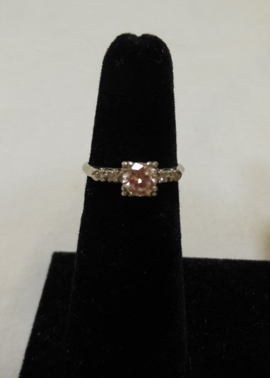 Vintage Platinum & Diamond Engagement Ring: Vintage platinum and diamond engagement ring. One solitaire round diamond (60 point) with four flanking smaller diamonds. Weight including gems approximately 3.4 grams. Size 6. In excellent condition.