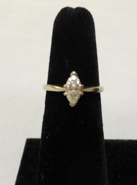 14K Gold Marquis Solitaire Diamond Ring: 14 karat white gold ring with a marquis solitaire diamond. One half plus carat. 2.1 grams including diamond. Size 5.5. In excellent condition. Please view our previous lot for an engagement ring jacke