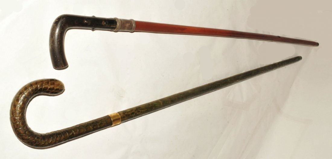 Pr. Antique Canes G.B. Reptile & 9K Gold Band: Pair of antique cane and walking stick from Great Britain. The first is covered with a green alligator hide and has a marked gold band around the shaft, with hallmark: "18ct G.B." (Great Britain) and