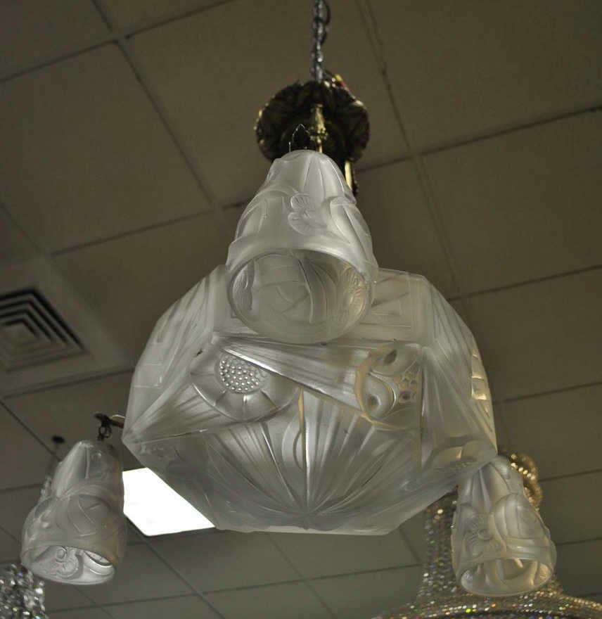 Degue French Art Glass Art Deco Chandelier: Antique French frosted art glass Art Deco chandelier signed Degue. Having a large central domed glass shade with three smaller shades, showing Art Deco lines and floral motif designs. Three bronze ste