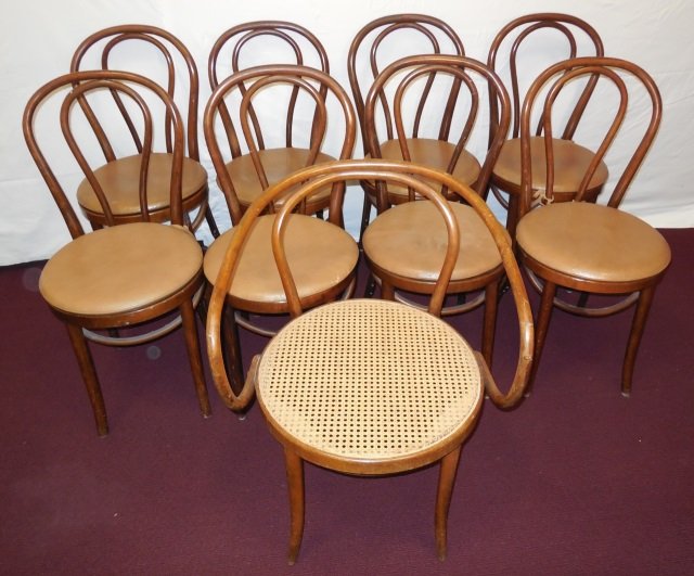 Set of 9 Thonet Style Bentwood Arm & Side Chairs: A lot of nine Thonet arm and side chairs. Eight side chairs 16" W x 17 3/4" D x 35 3/8" H. One armchair with caned seat, 23 1/2" W x 22 1/2" D x 31 3/8" H. Very good condition.