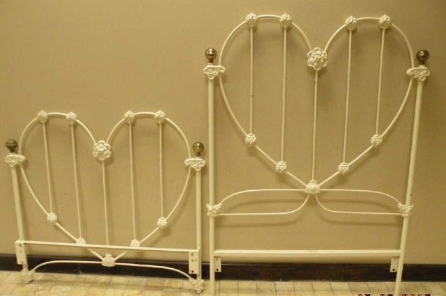 Antique Victorian Cast Iron Painted Bed Frame: Antique Victorian cast iron painted bed frame. Heart motif. White Painted. Cottage Victorian shabby chic style. Head board measures 56 inches in height and 40 inches in width.