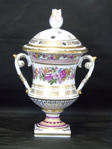 Painted Porcelain Urn Shaped Flower Holder: Painted porcelain urn shaped flower holder. Top has 15 holes for individual flowers. May also be used with out the top for small sprays of flowers. Predominately pinks and gold on white porcelain. 5 1