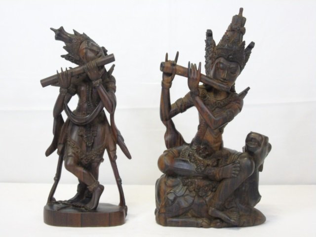 2 Balinese Carved Wood Sculptures: 2 Balinese carved wood sculptures of musicians. Larger: 7 1/2" x 4" D x 15" H, smaller: 5 1/2" W x 4" D x 13" H. Very good condition.