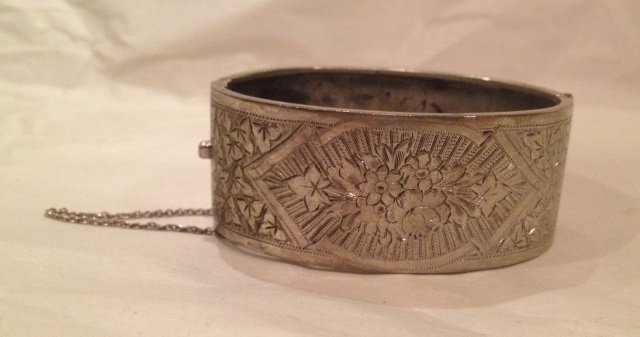 Antique Victorian Chased Silver Cuff Bracelet: Antique Victorian Chased Silver Cuff Bracelet. Ornate floral motif chased work design, original safety chain. Marked silver. Interior opening measures 2.5 inches wide, cuff is 1 inch in depth.