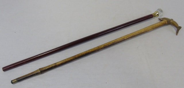 Lot of 2 Vintage Canes Walking Sticks: Lot of 2 vintage canes walking sticks. Glass "door knob" handle and solid brass dolphin head. Both are 35" long. Good vintage condition.