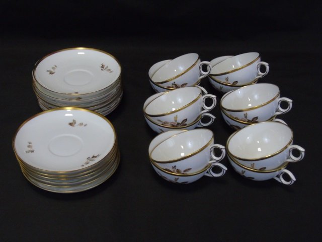 Royal Copenhagen Denmark 12 Cups & Saucers: Royal Copenhagen Denmark 12 Cups and Saucers. Each with gilt gold border, gilt decoration, and floral motif. Saucers measure 5.5 inches in diameter.
