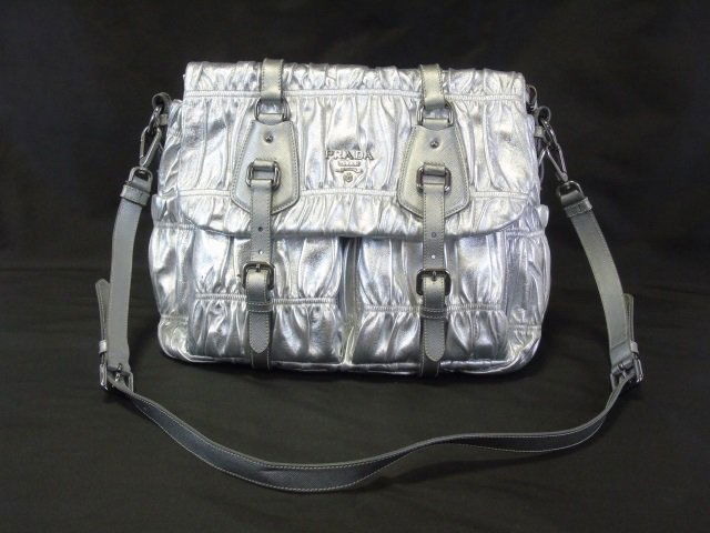 Prada Silver Nappa Gaufre Anti Hand Bag: Large Silver Leather Prada Hand Bag. Overall very nice condition. Original retail price of $2,680. Paperwork included. Black lined interior. Measures 16 by 12 approximately, strap measures 42 inches a