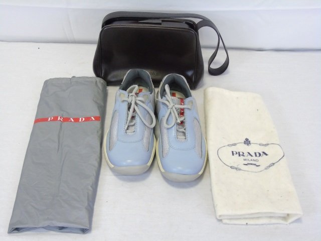 Prada Leather Purse & Sneakers: Prada Leather Purse & Sneakers. Original paperwork included inside of purse. Original dust covers. Purse measures 10.5 inches in width.